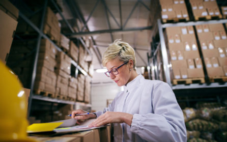 woman completing paperwork as part of the apparel supply chain