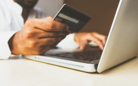 Man making online purchases with a laptop and credit card